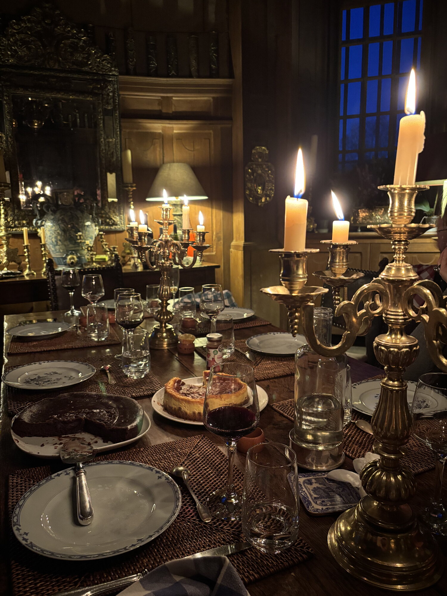 A long table laid and lit by candles